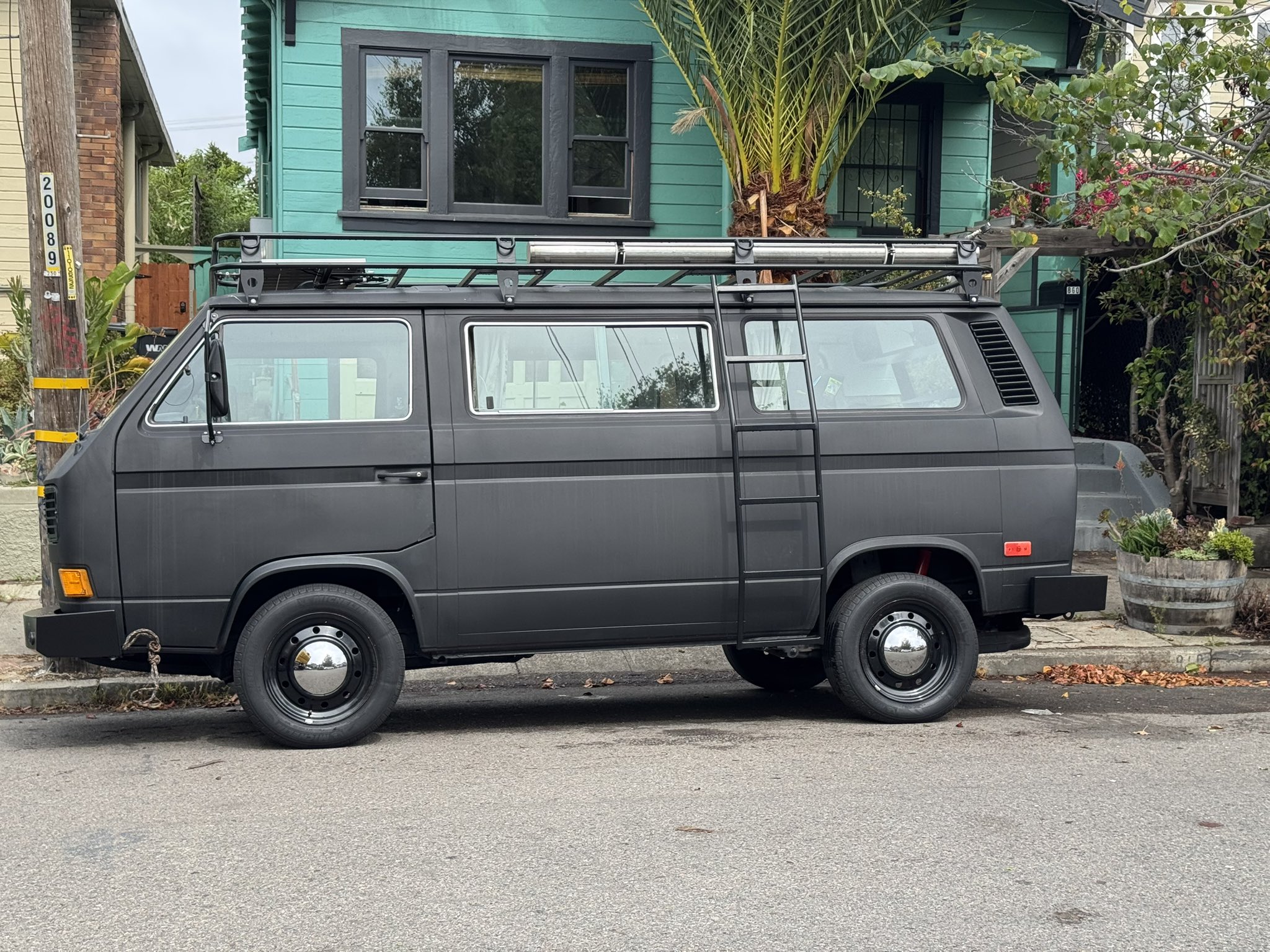 Kalavajra, a dark grey Vanagon with roof rack, parked on an Oakland street